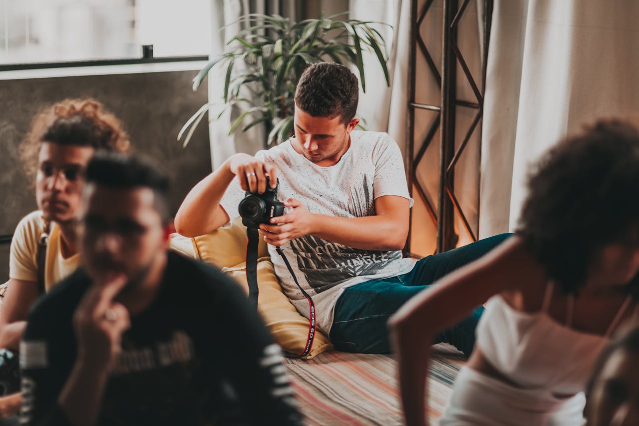 Young photographers work together in a creative, indoor studio workshop setting.